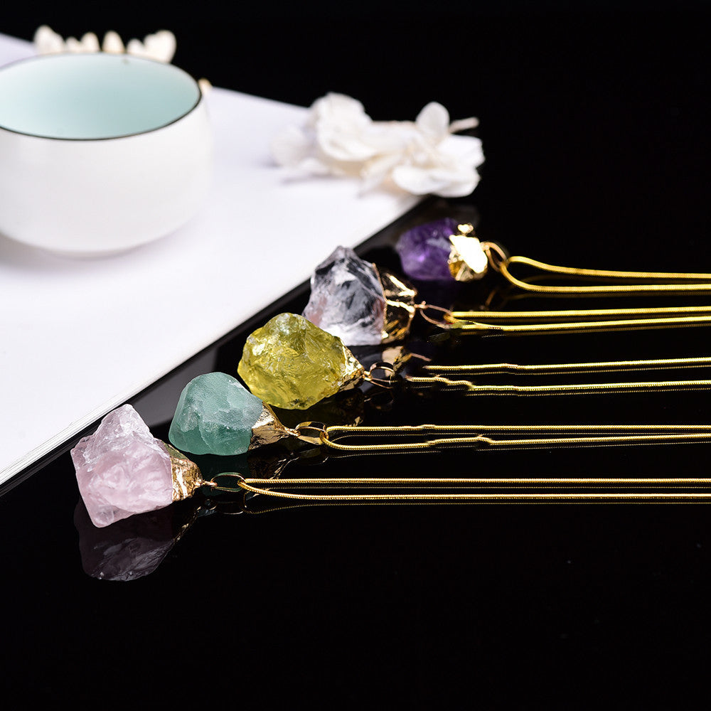 Gold hairpins with gemstones on a black surface