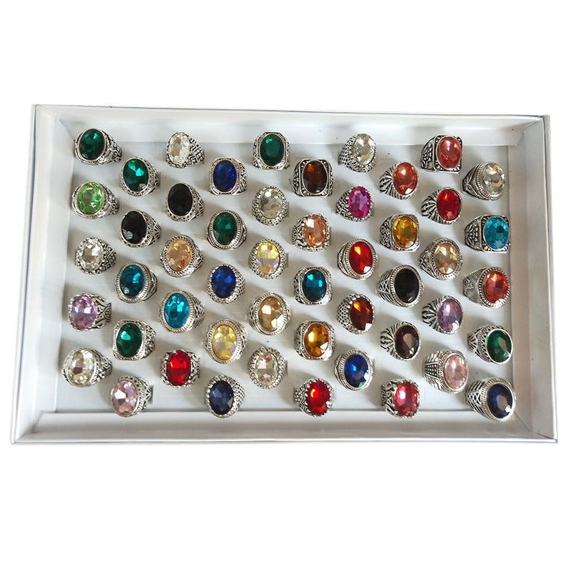 Collection of colorful rings displayed in a white tray