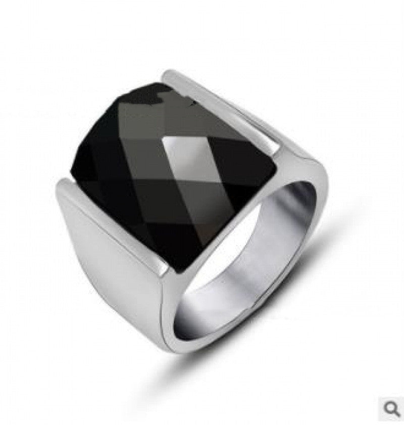 Silver ring with a black gemstone on a white background