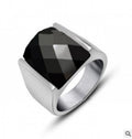 Silver ring with a black gemstone on a white background