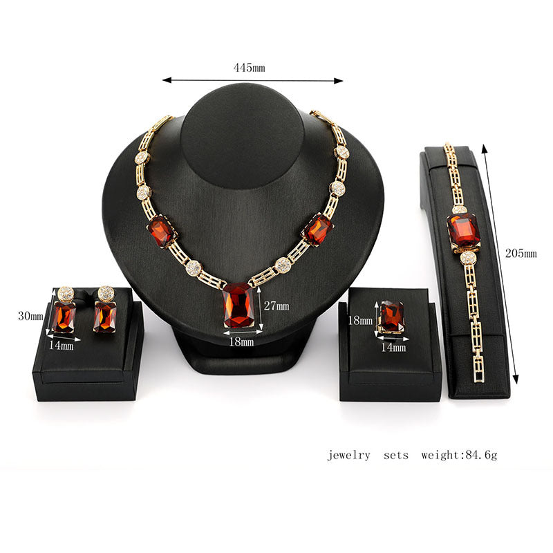 Jewelry set with necklace and bracelet on a black stand, showing measurements.