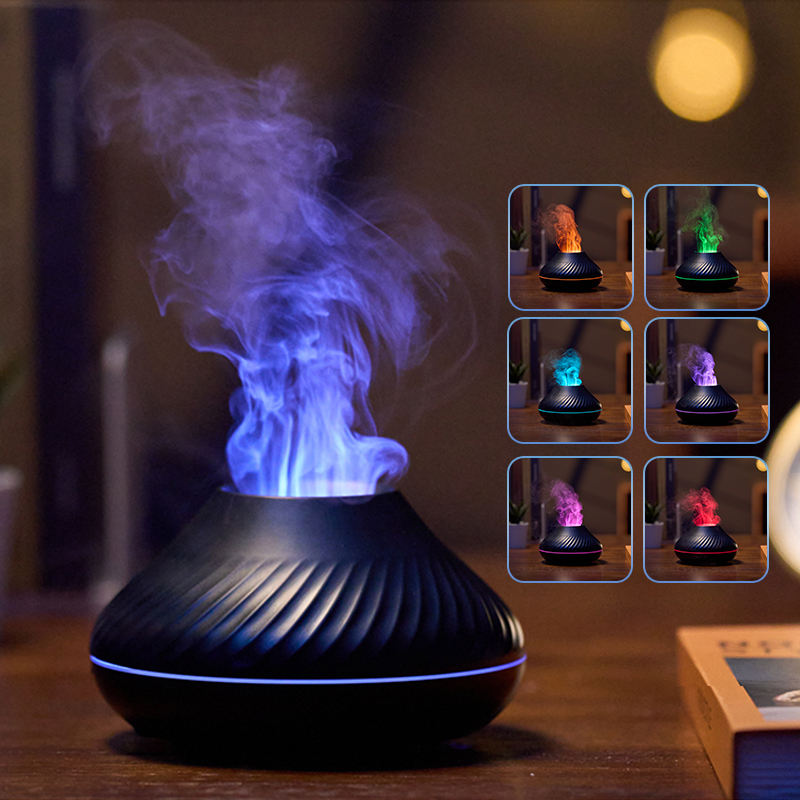 Black essential oil diffuser with colorful lights and smoke on a wooden surface.