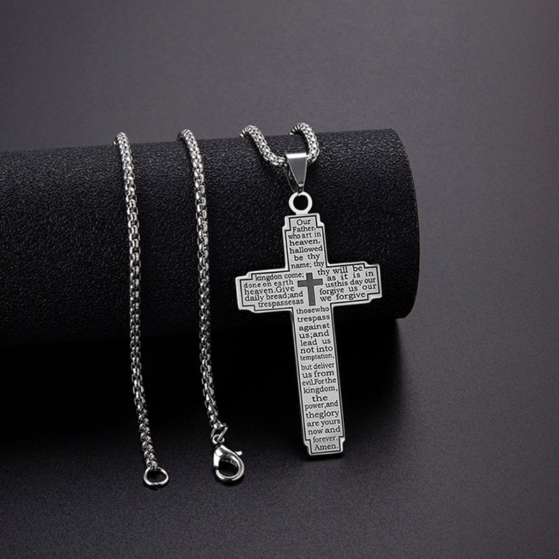 Silver cross pendant necklace with engraved text on a black background