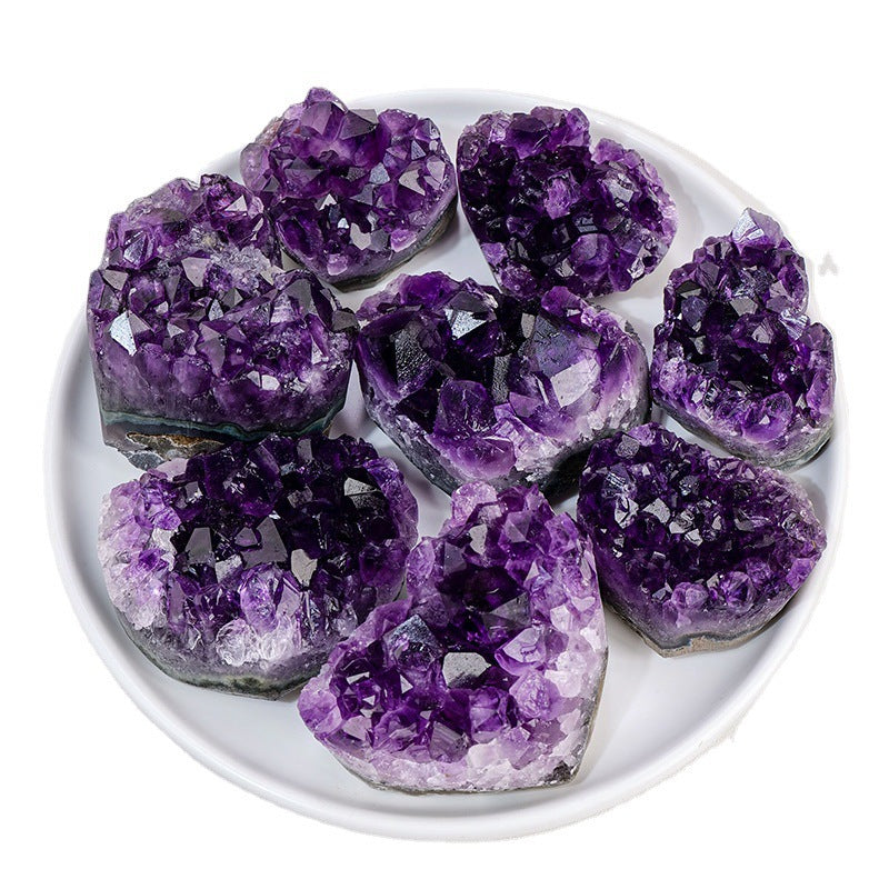 Amethyst crystal clusters on a white plate