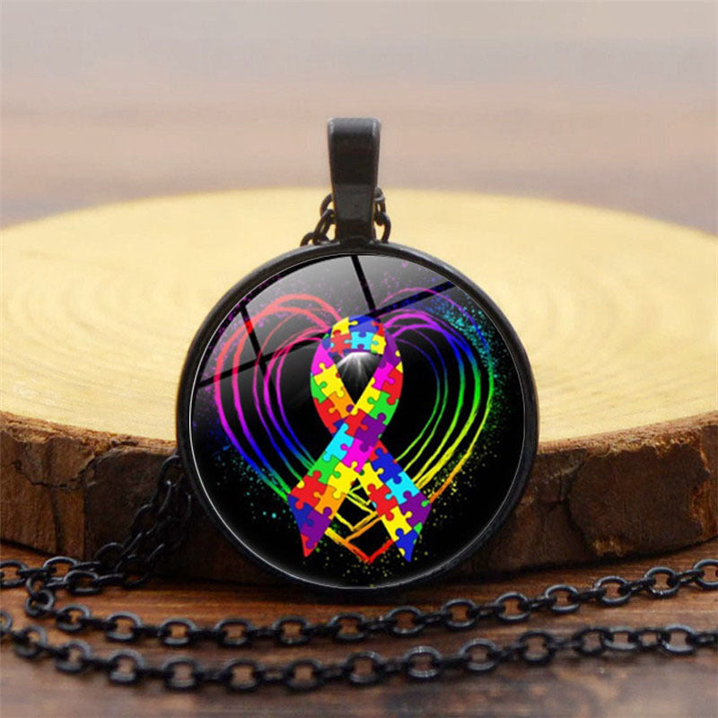 Necklace with a colorful ribbon pendant on a wooden surface