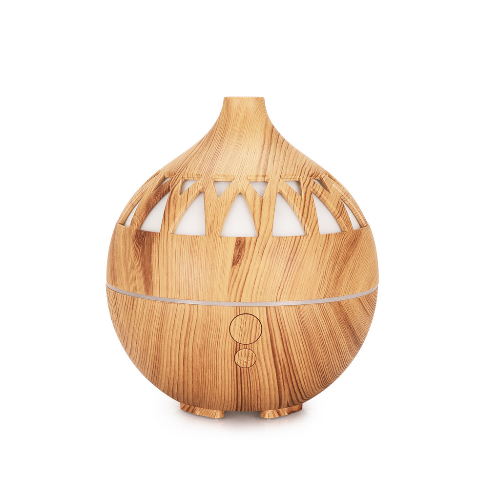 Wooden diffuser with cut-out design on a white background