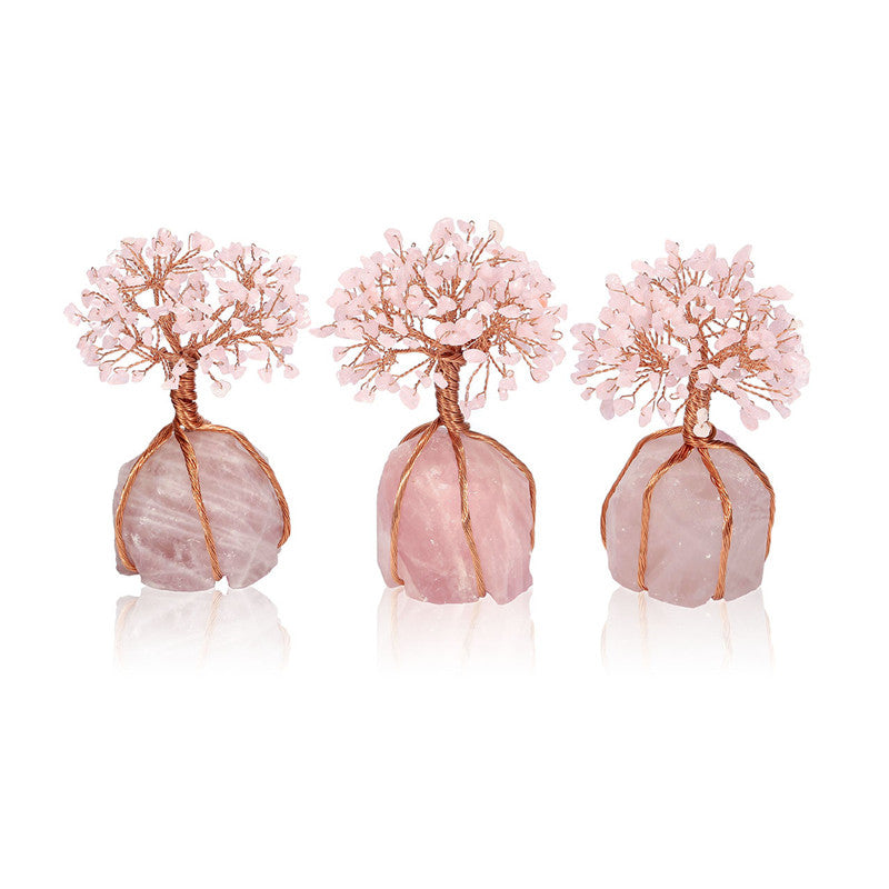 Three pink tree-shaped earrings with rose gold bases on a white background