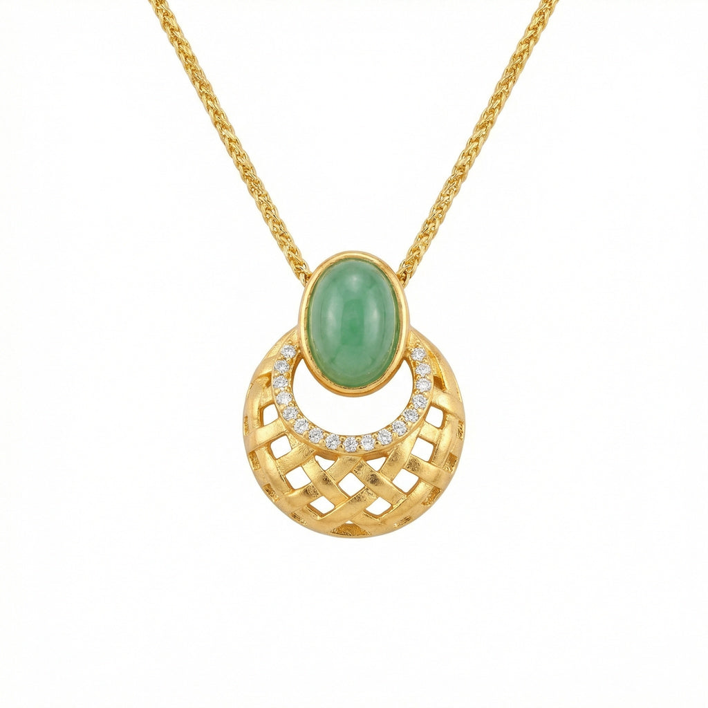 Gold necklace with a green gemstone pendant on a white background