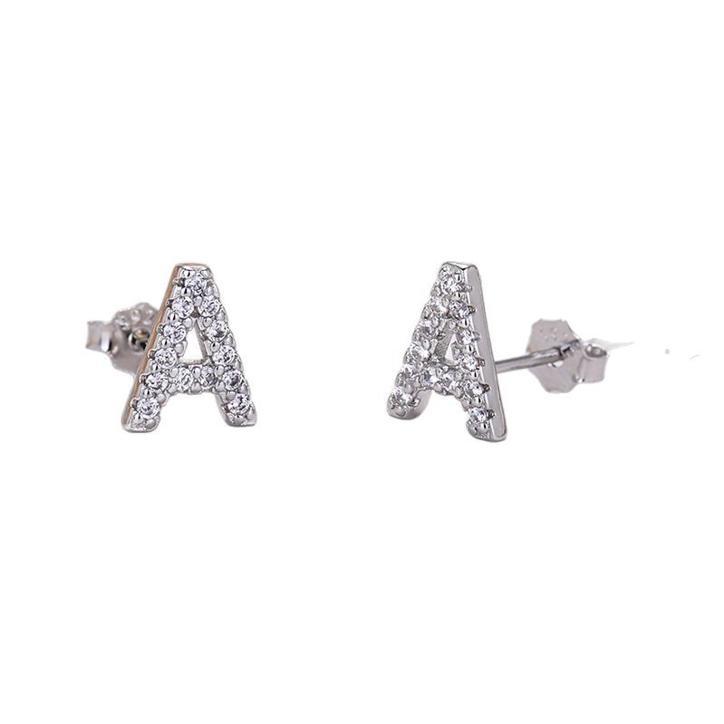Silver 'A' letter earrings with clear stones on a white background
