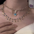 Necklace with heart-shaped blue gemstone on a mannequin