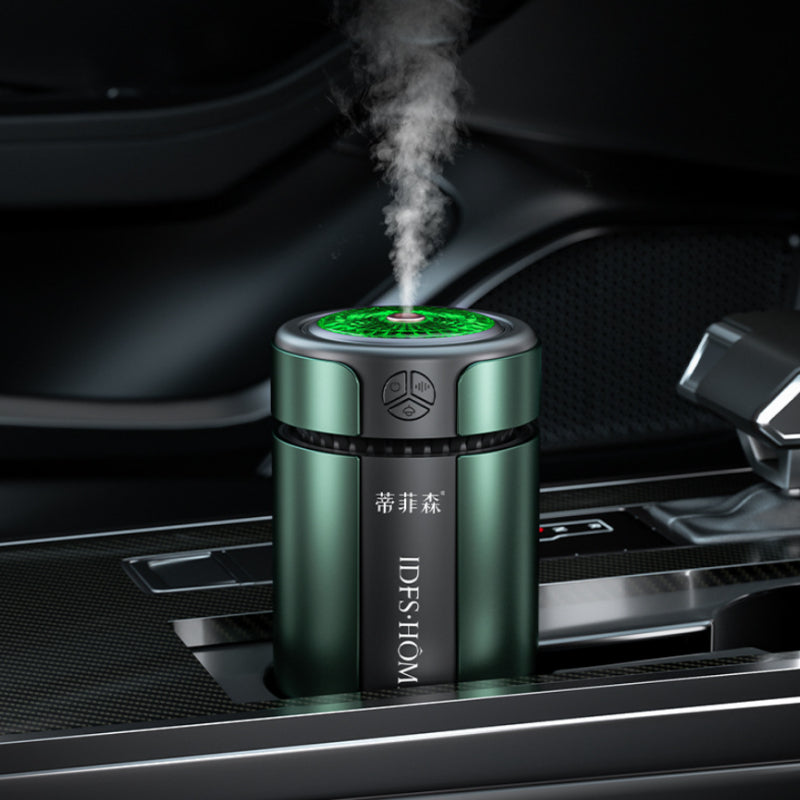 Green and black diffuser emitting steam in a car's air vent.