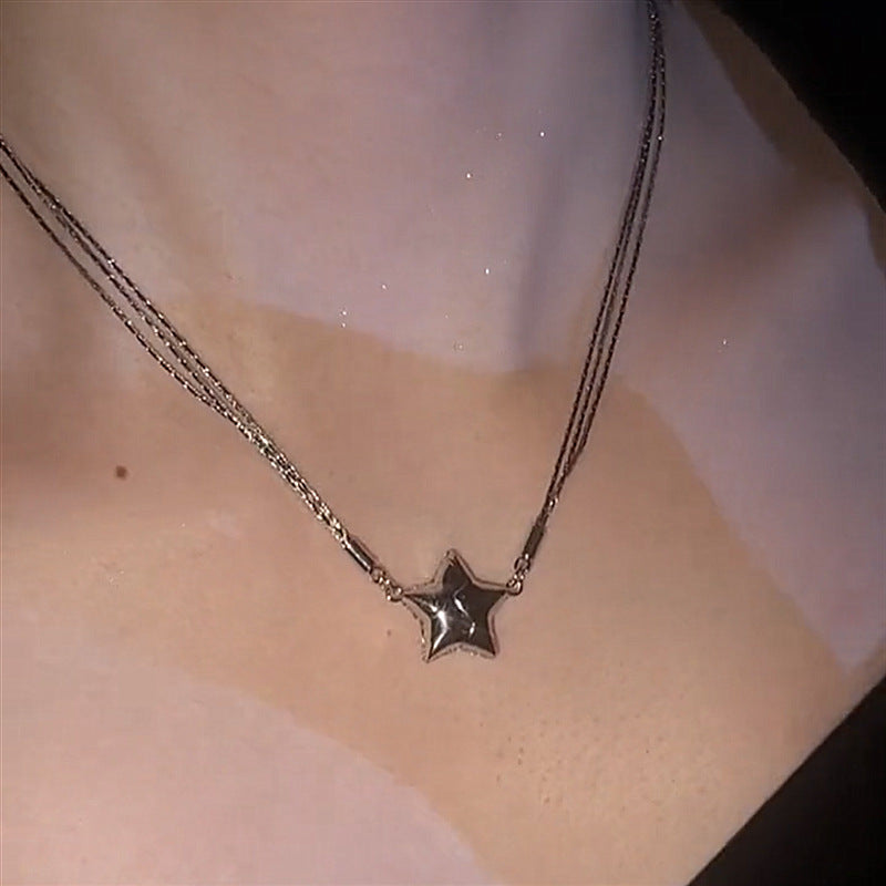 Star-shaped pendant necklace on a person's neck