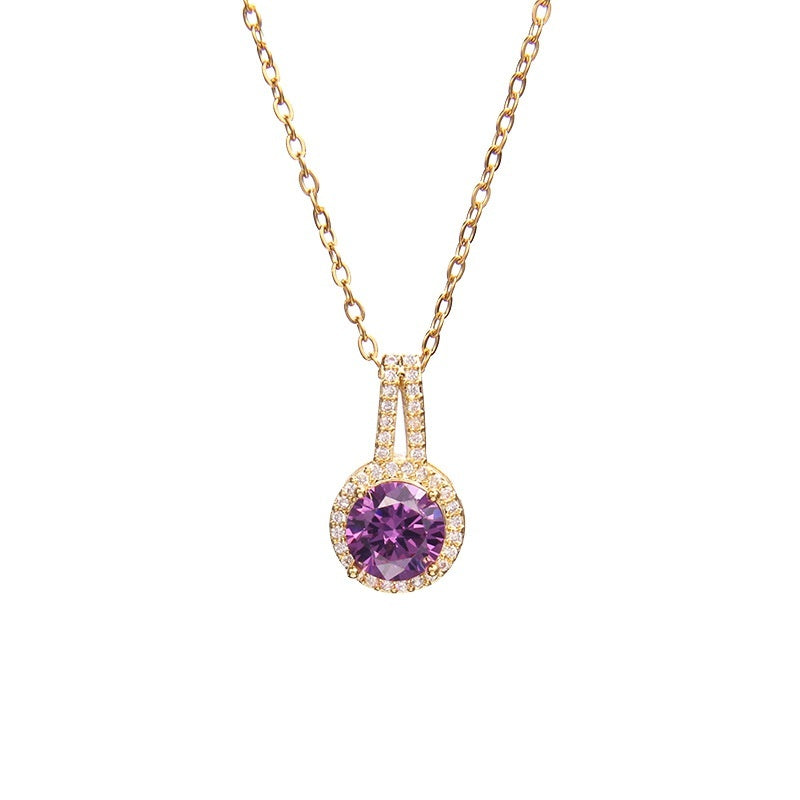 Gold necklace with a purple gemstone pendant on a white background