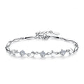 Silver bracelet with diamond accents on a white background