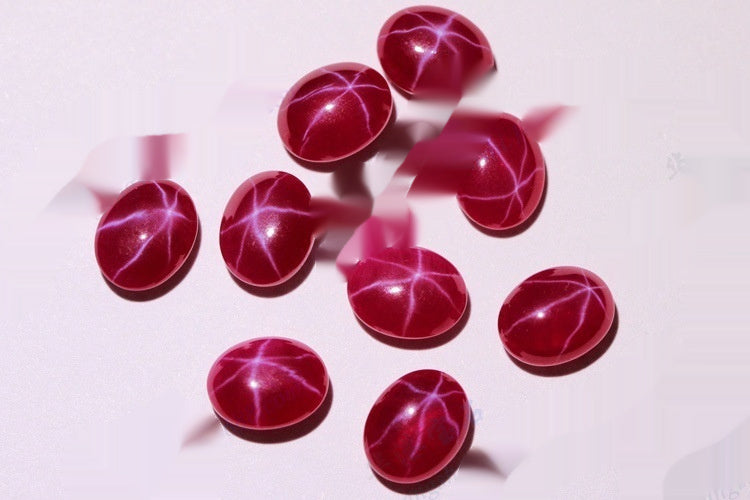 Red gemstones with star-like patterns on a white background