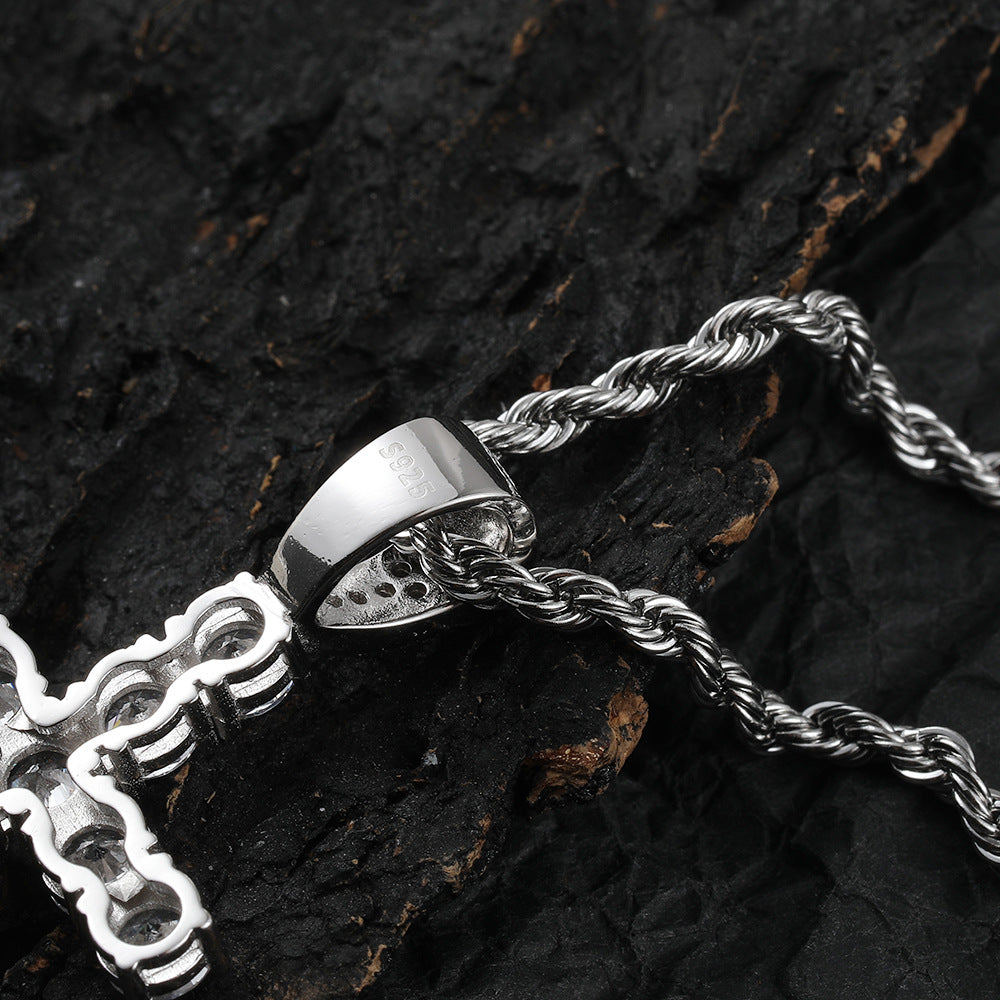 Silver chain necklace with a decorative clasp on a dark wooden surface