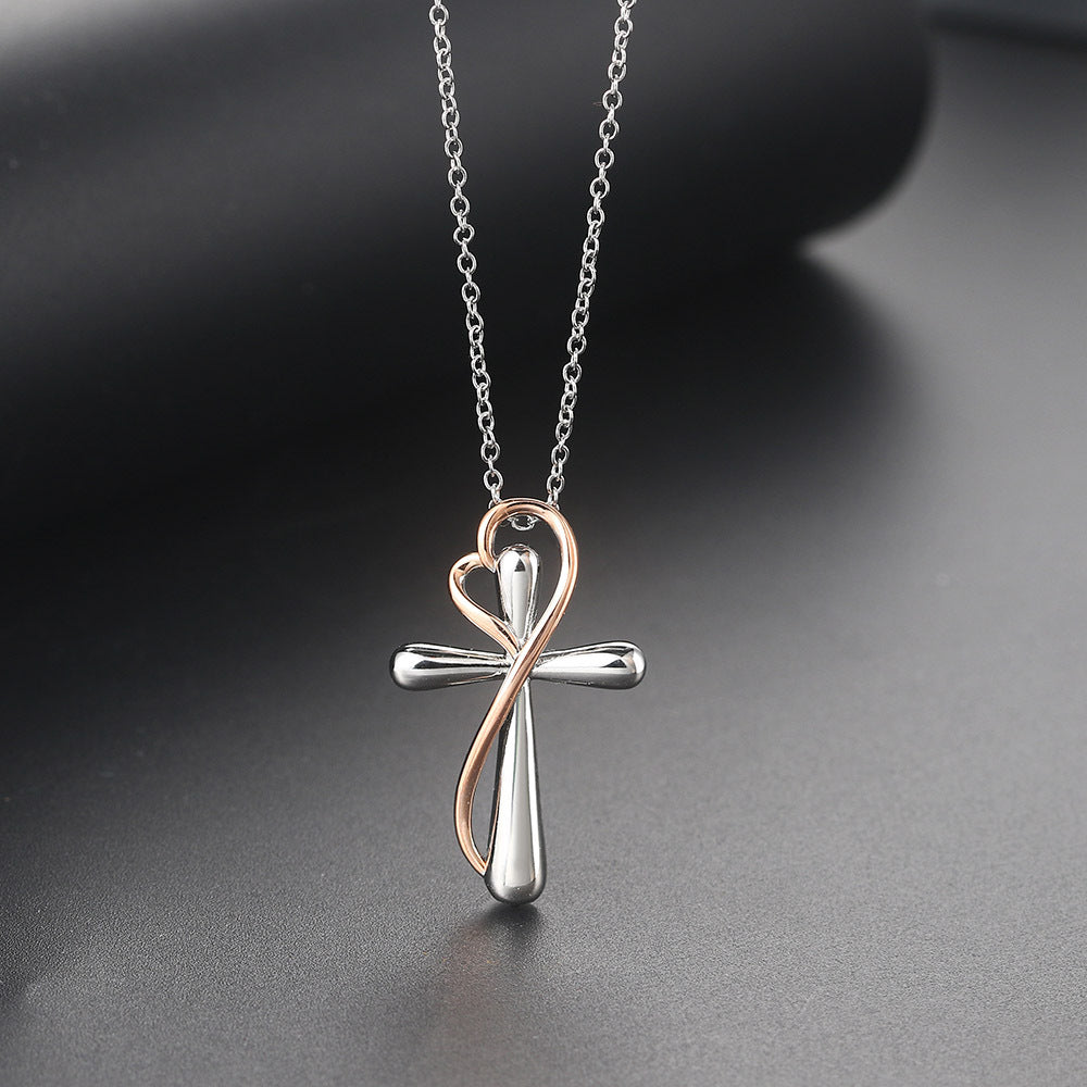Silver cross pendant necklace on a dark background