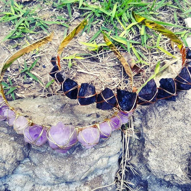 Necklace with purple and black gemstones on a natural background