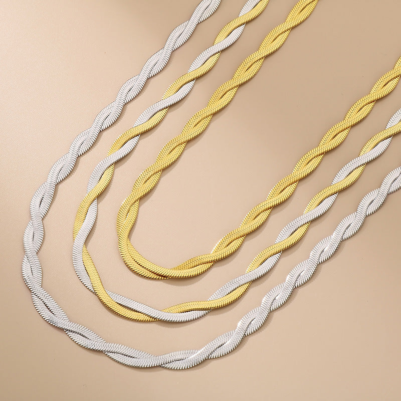 Two necklaces, one white and one yellow, on a beige background