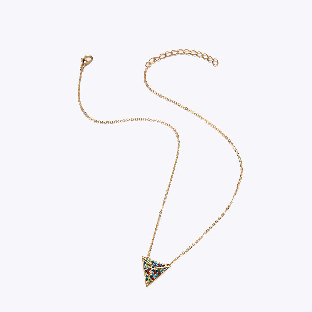 Gold necklace with a triangle-shaped pendant on a white background
