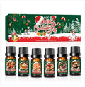 Set of Christmas-themed essential oil bottles with a decorative box in the background.