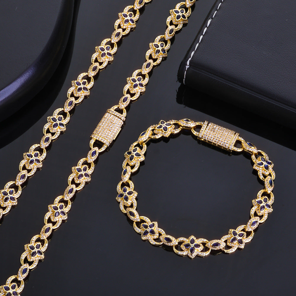 Gold necklace and bracelet set on a black background