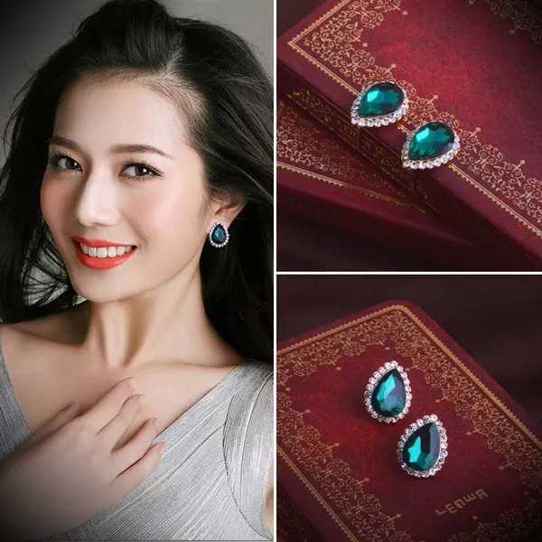 Woman wearing green teardrop earrings with close-up shots of the earrings on a red background.