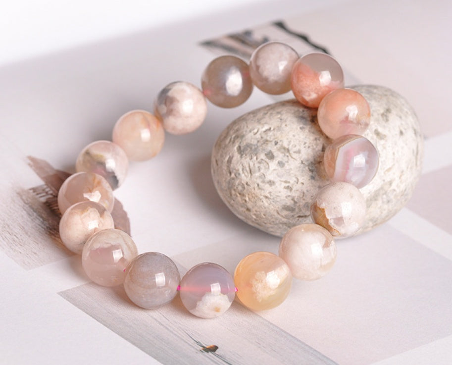 Necklace with pink and white beads on a white surface