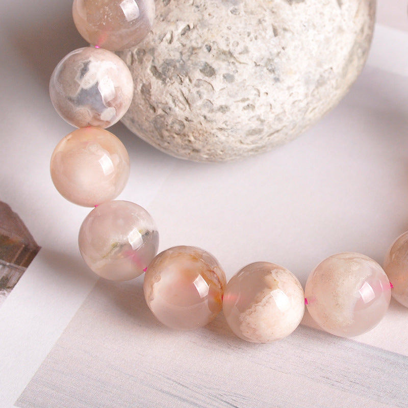 Necklace with peach-colored beads on a light surface