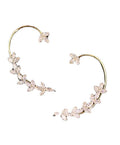 Gold hoop earrings with floral designs on a white background