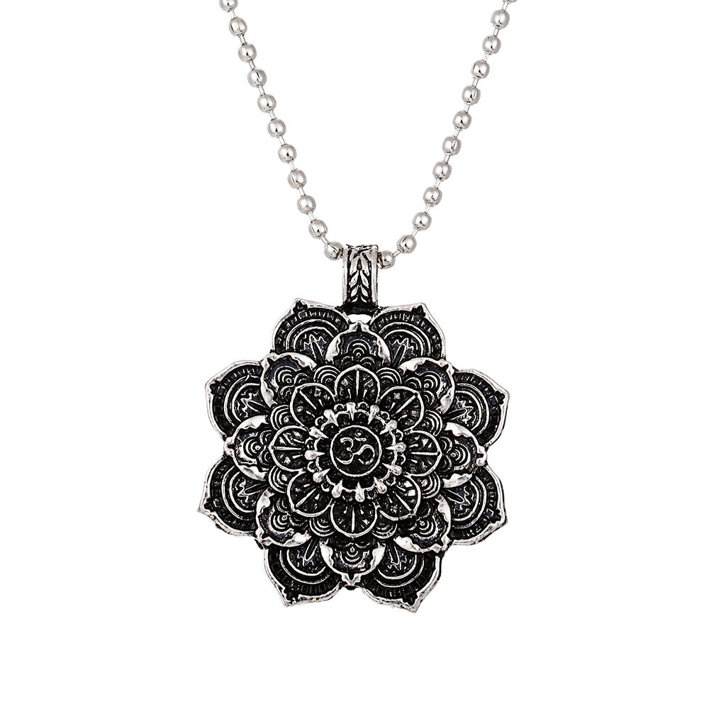 Black mandala pendant necklace on a white background