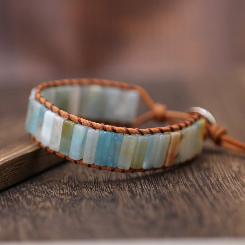 Multicolored beaded bracelet on a wooden surface with a blurred background