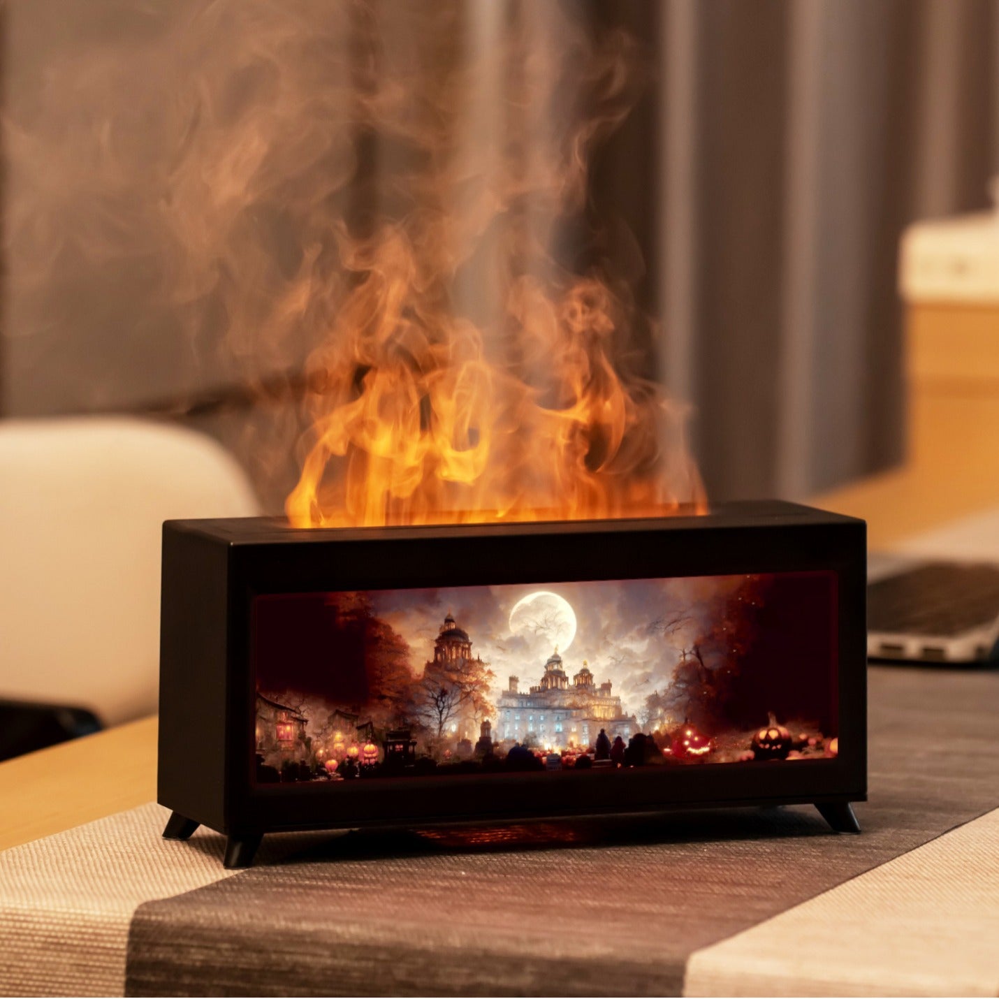Small electric fireplace with flames and scenic display on a table.