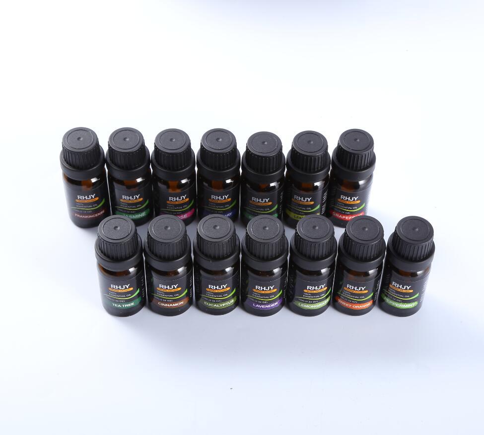 Multiple small black bottles with labels on a white background