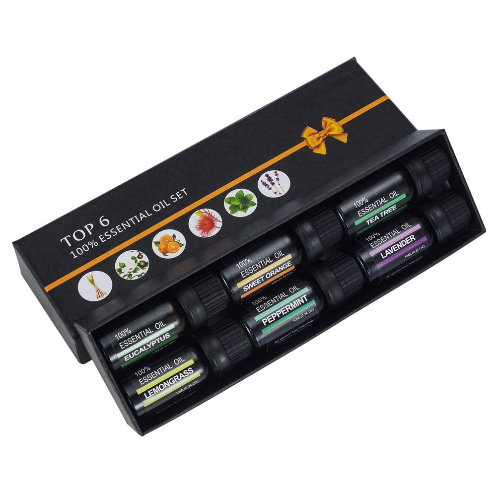 Set of 6 essential oil bottles in a black box with colorful labels on a white background