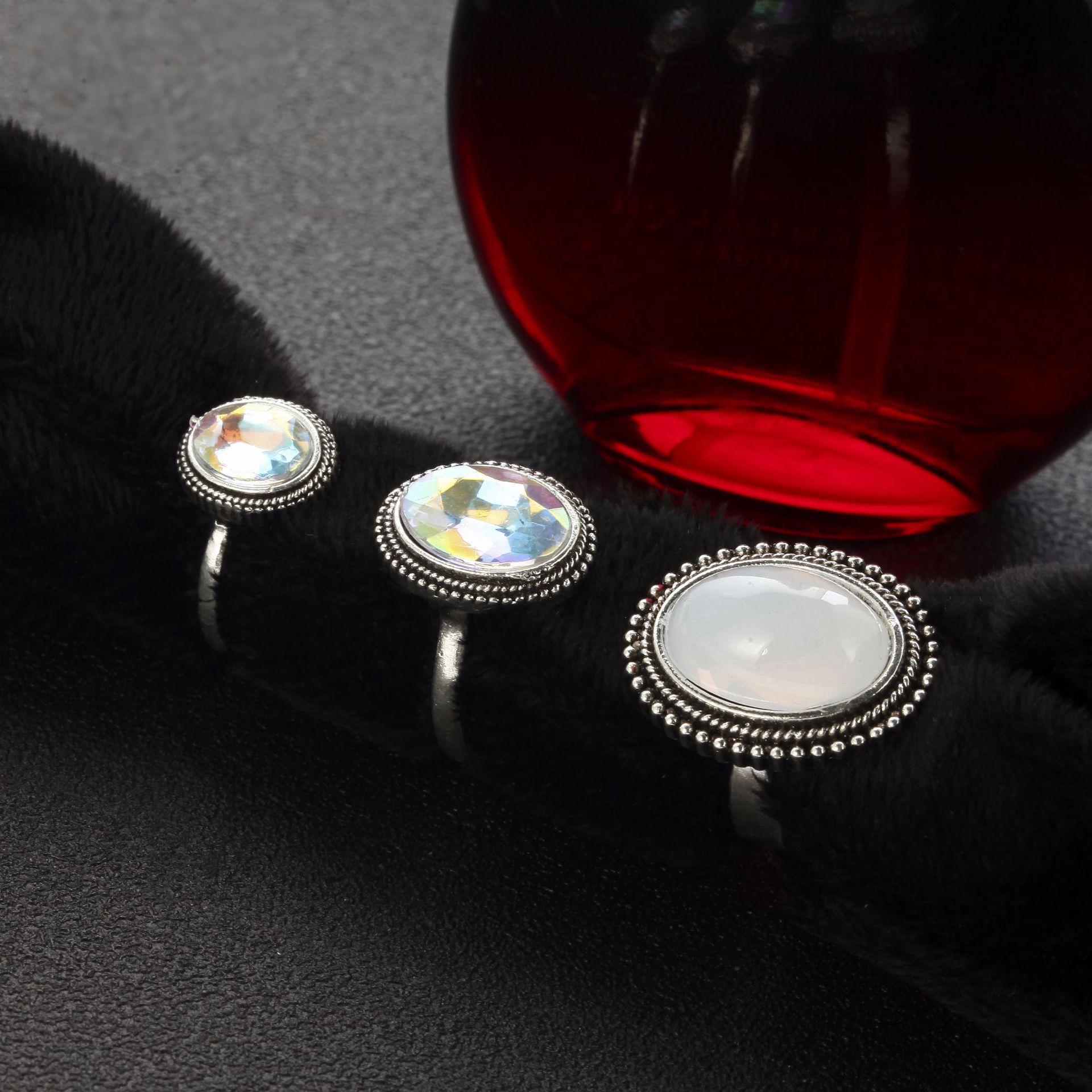Silver rings with gemstones on a dark surface