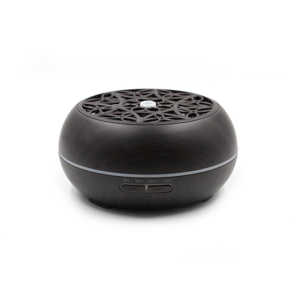 Black diffuser with intricate design on a white background