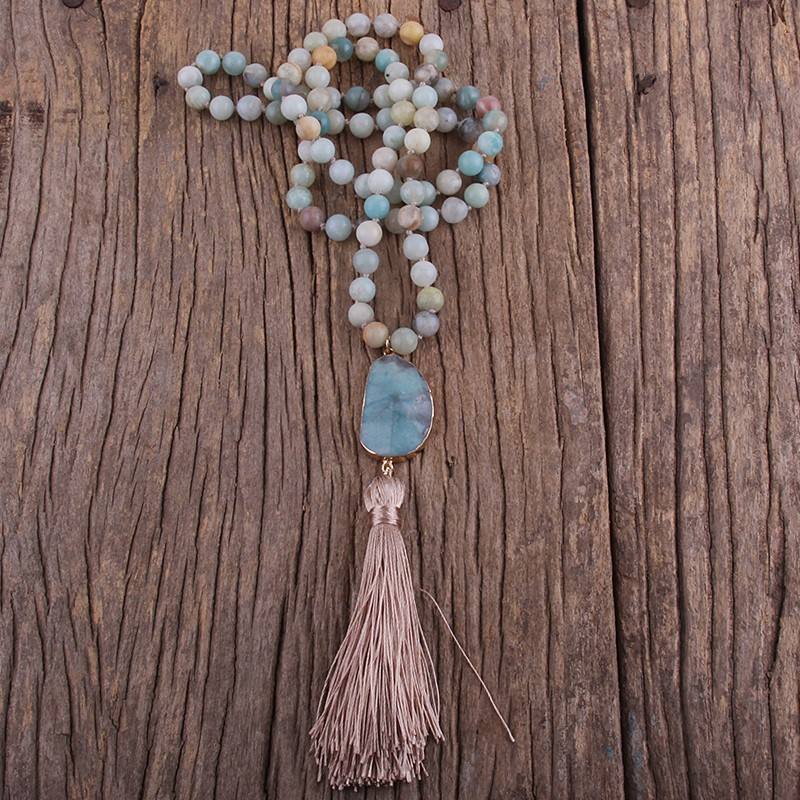 Necklace with beads and tassel on a wooden surface