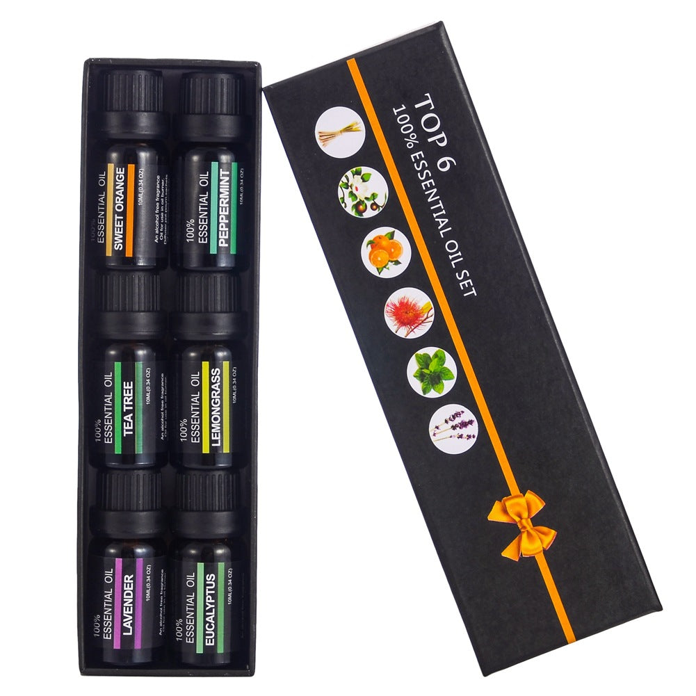Set of essential oils in a gift box with a bow on a white background
