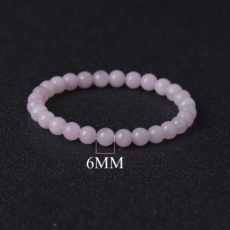 Pink beaded bracelet with '6MM' label on a black background