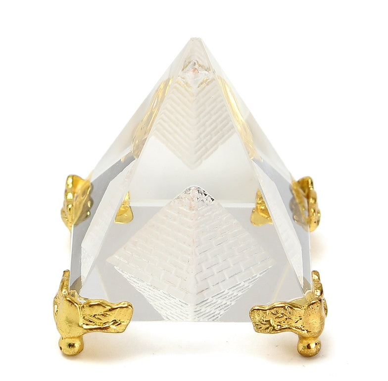 Crystal pyramid with gold accents on a white background