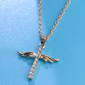 Gold cross necklace with wings and diamonds on a blue background
