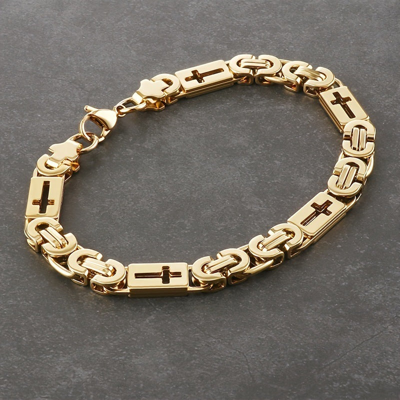 Gold bracelet with cross designs on a dark gray background