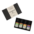 Set of four essential oil bottles in a black box with a branded label on a white background