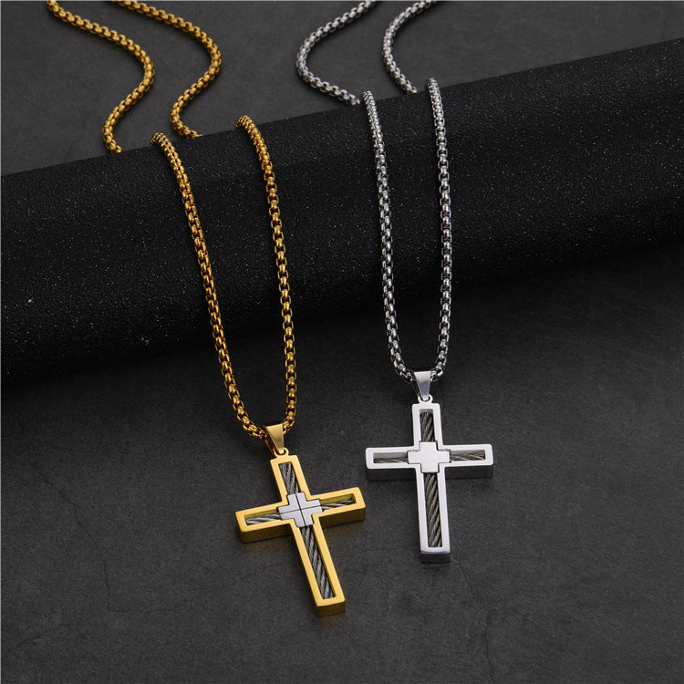 Two cross necklaces, one gold and one silver, on a dark surface.