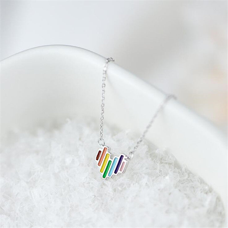Necklace with a colorful pendant on a white surface