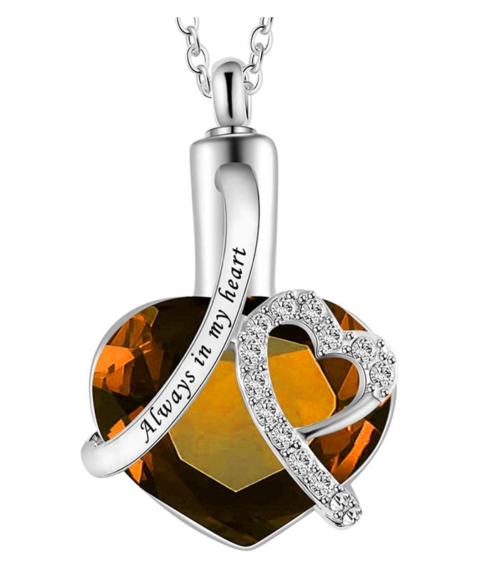 Silver necklace with heart-shaped pendant and 'Always in my heart' engraving on a white background