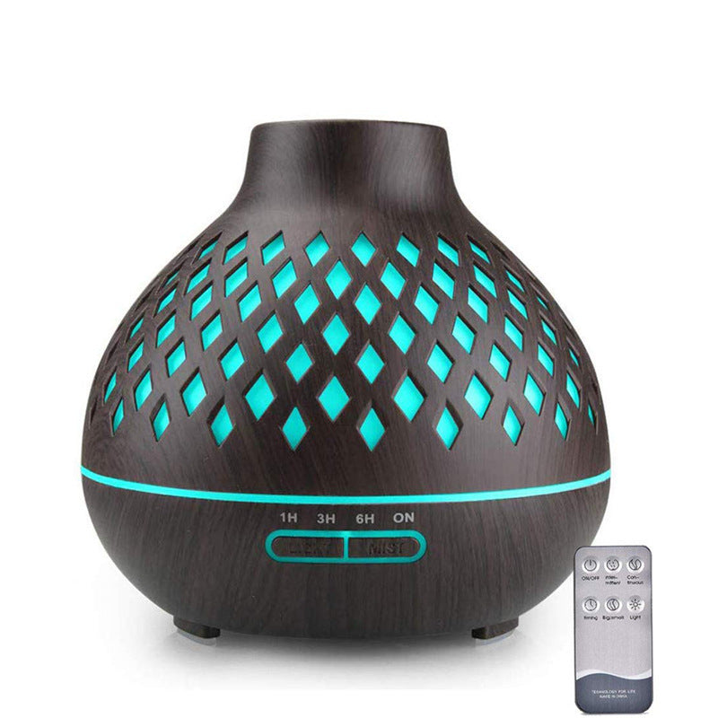 Aromatherapy diffuser with wooden texture and teal lights, accompanied by a remote control on a white background.