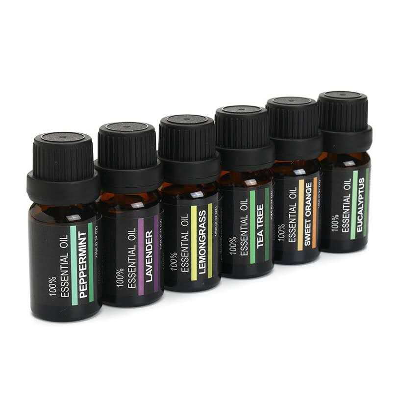 Set of essential oil bottles with black caps on a white background