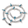 Bracelet with blue triangle accents and clear stones on a white background